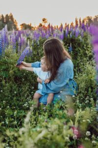Mother practicing slow motherhood, spending mindful time with her child in nature