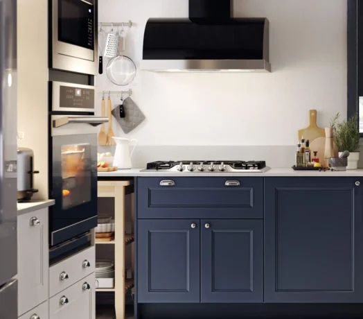 modern rustic kitchen with navy blue shaker cabinets,white contertops,and matte black range hood .