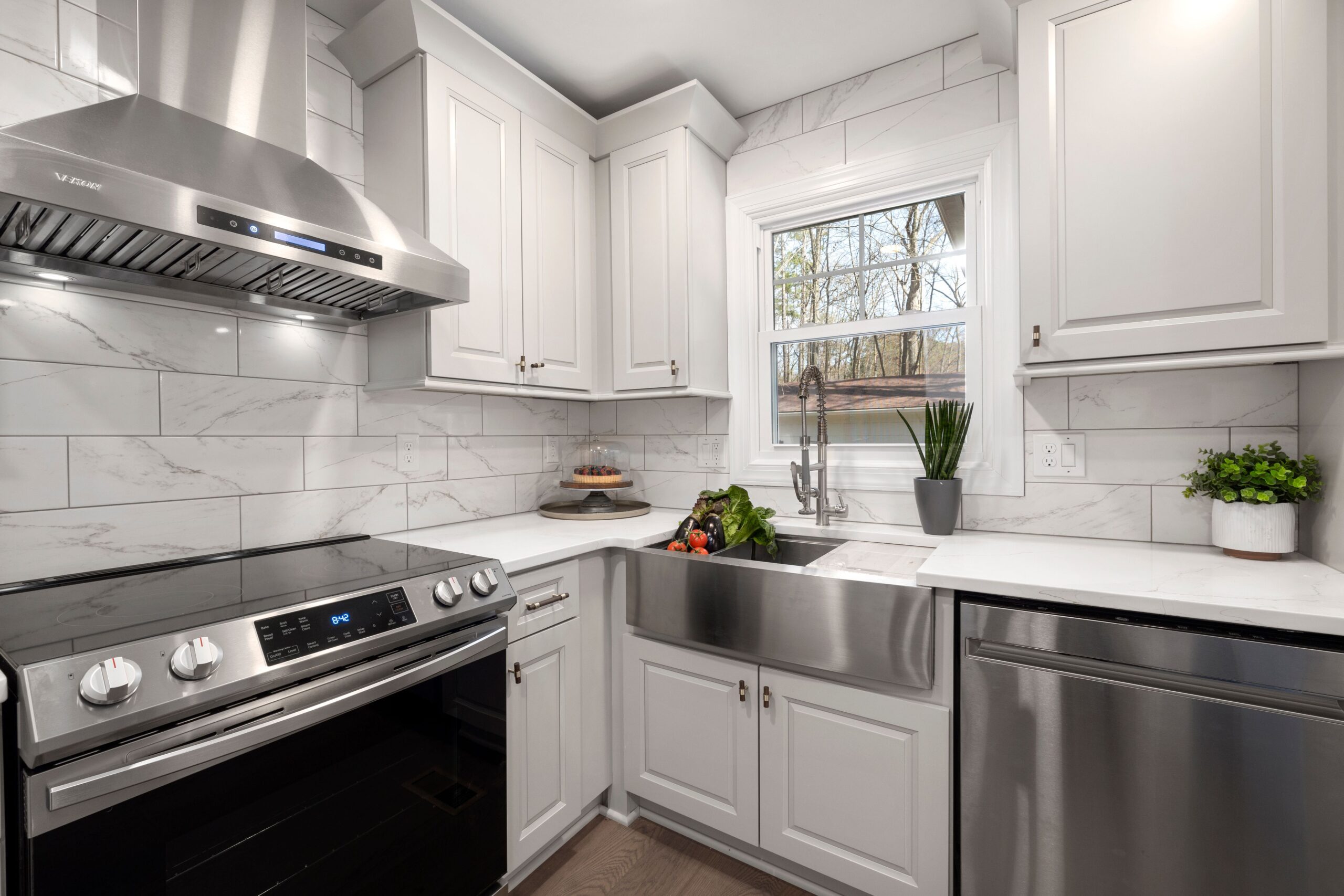 Kitchen hood cleaning: a modern range hood above a stainless steel stove