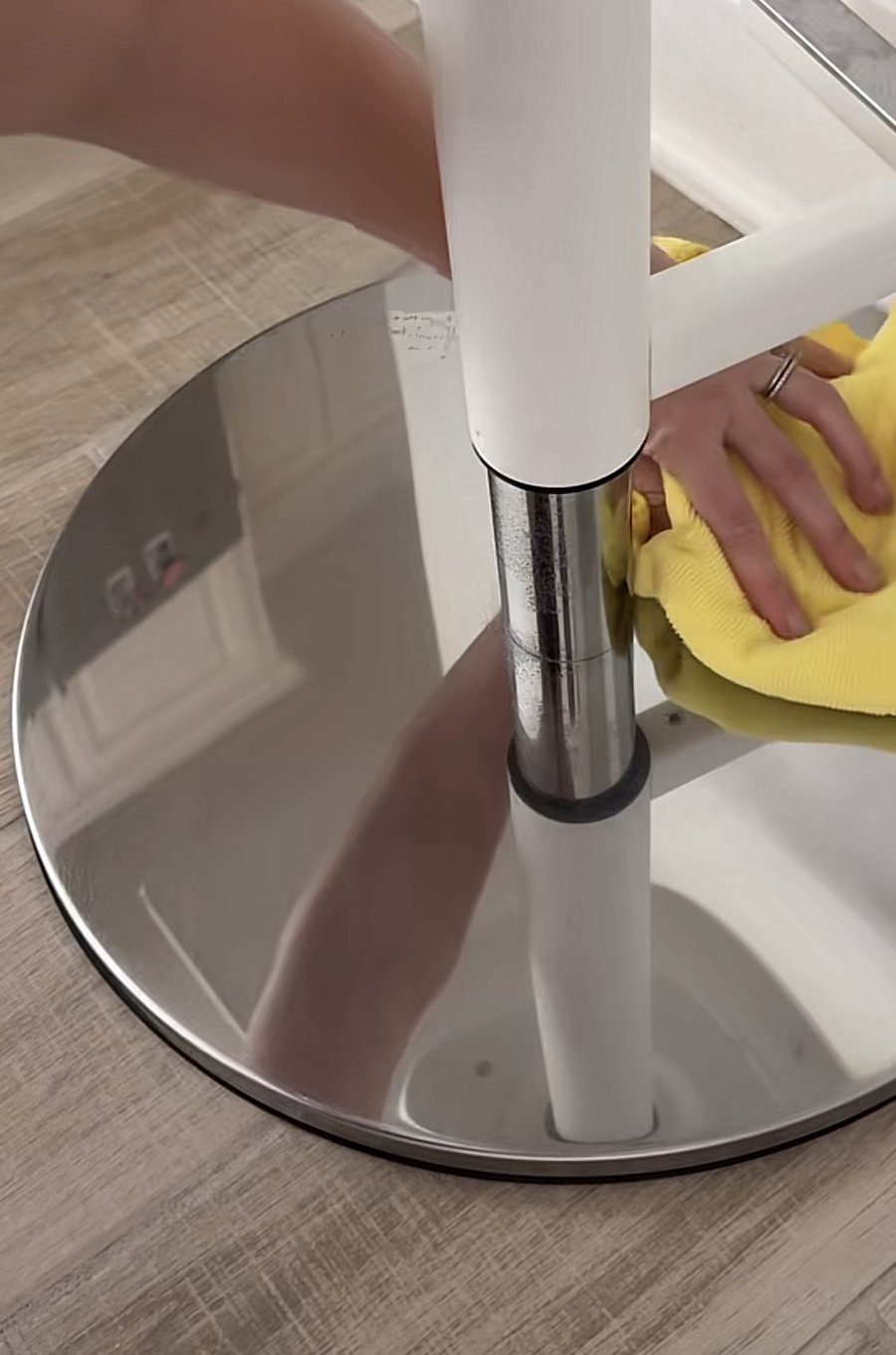 Chrome stool base with water spots and smudges before cleaning