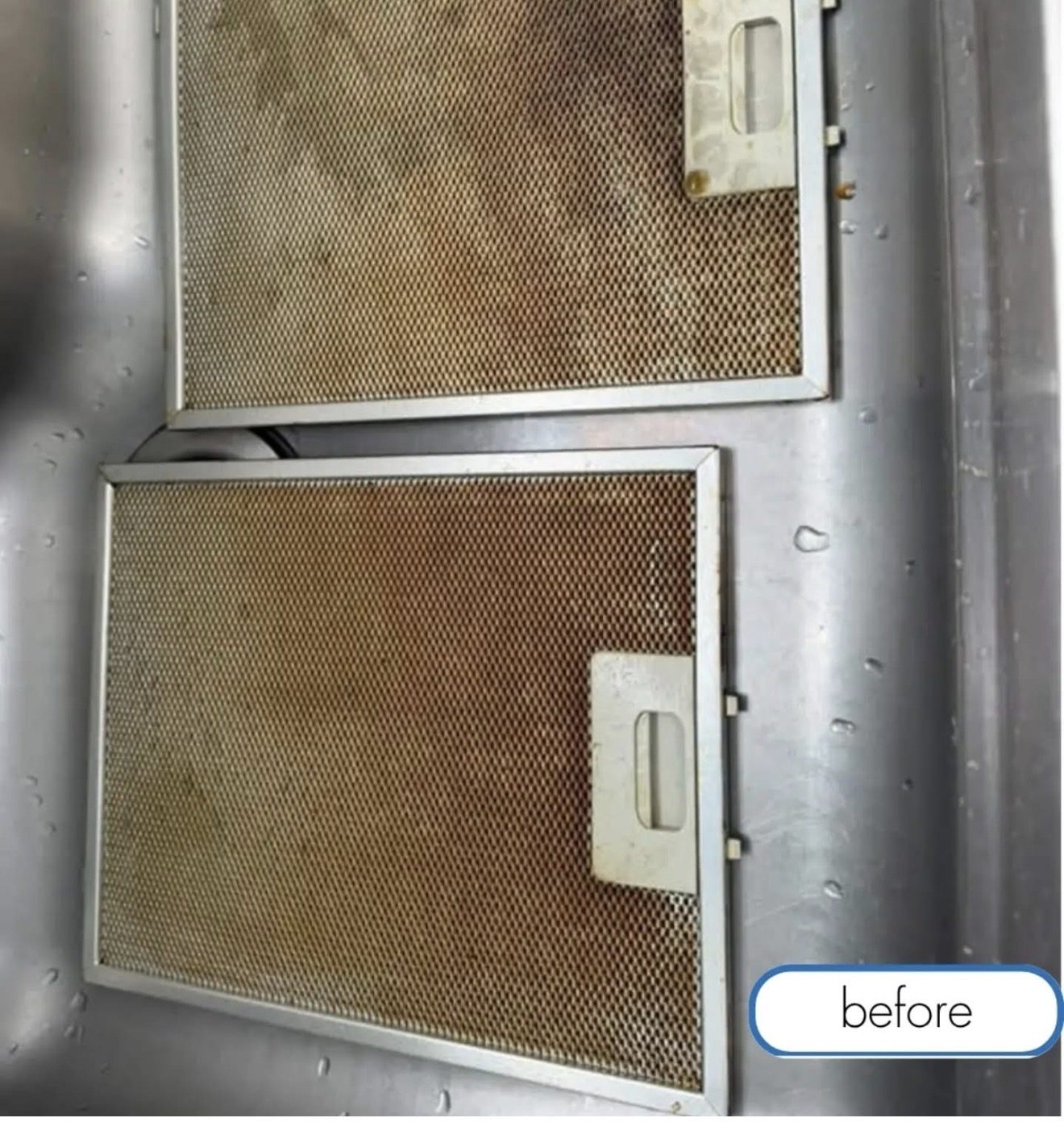 Greasy metal mesh range hood filters before cleaning